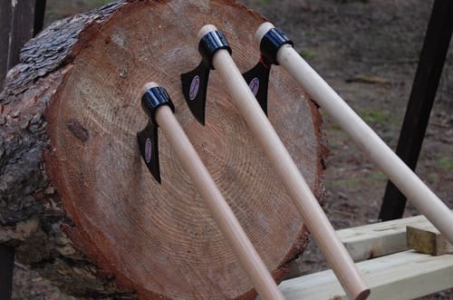 three axes on a wood piece