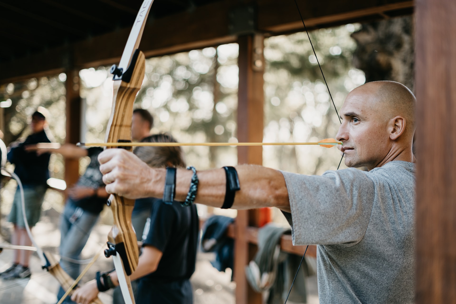 fun activities for businesses; person trying archery
