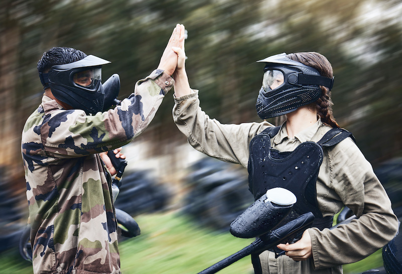 Adventurous couples, people in paintball gear.