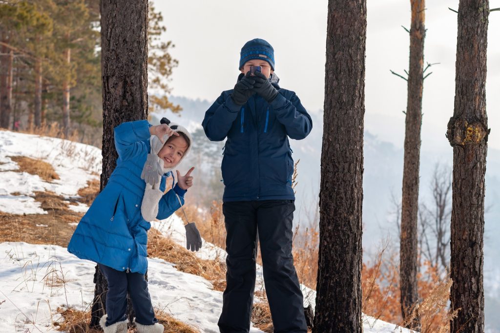 Active Christmas activities- A sibling duo playing in the snow