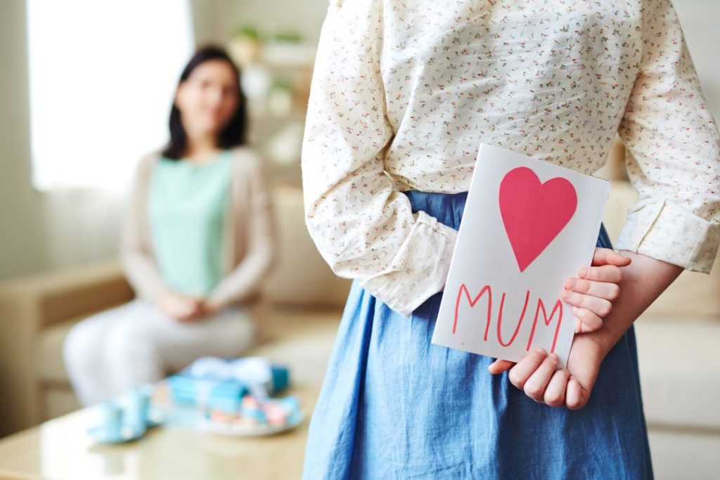 mothers day out, a daughter who's about to surprise her mum with a wishing card