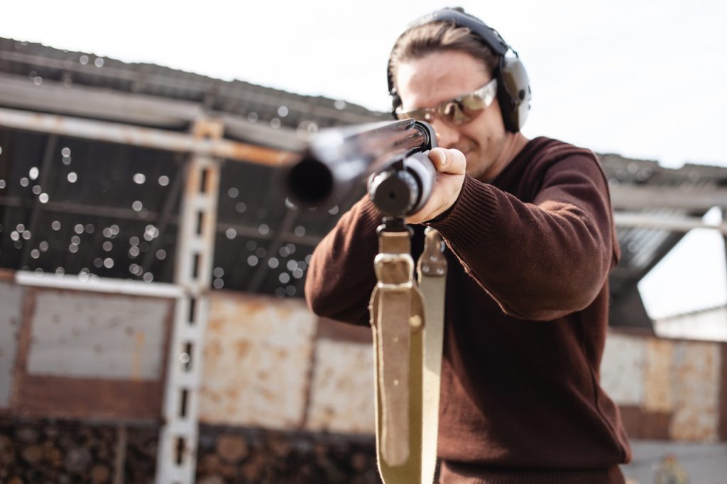 A man is getting practice before a clay pigeon shooting party.