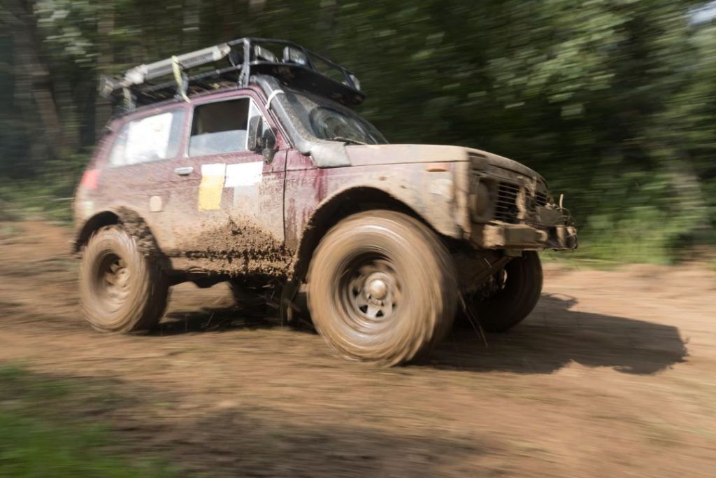 benefits of off-road driving, blurred shot of an off-road vehicle covered in dirt