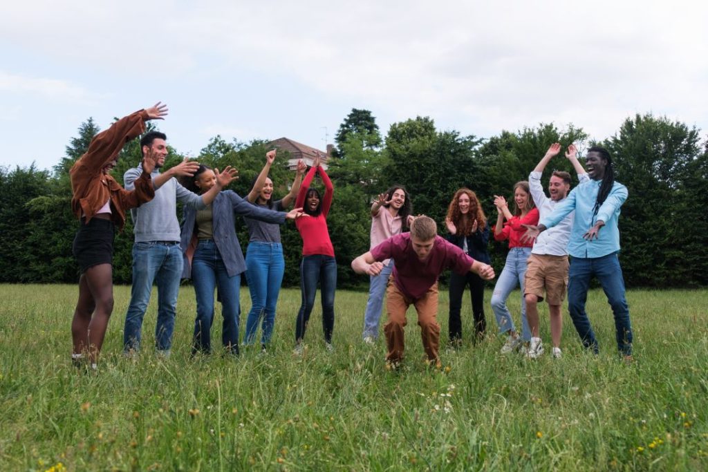 fun corporate event activities, young professionals applauding their colleague's celebratory dance