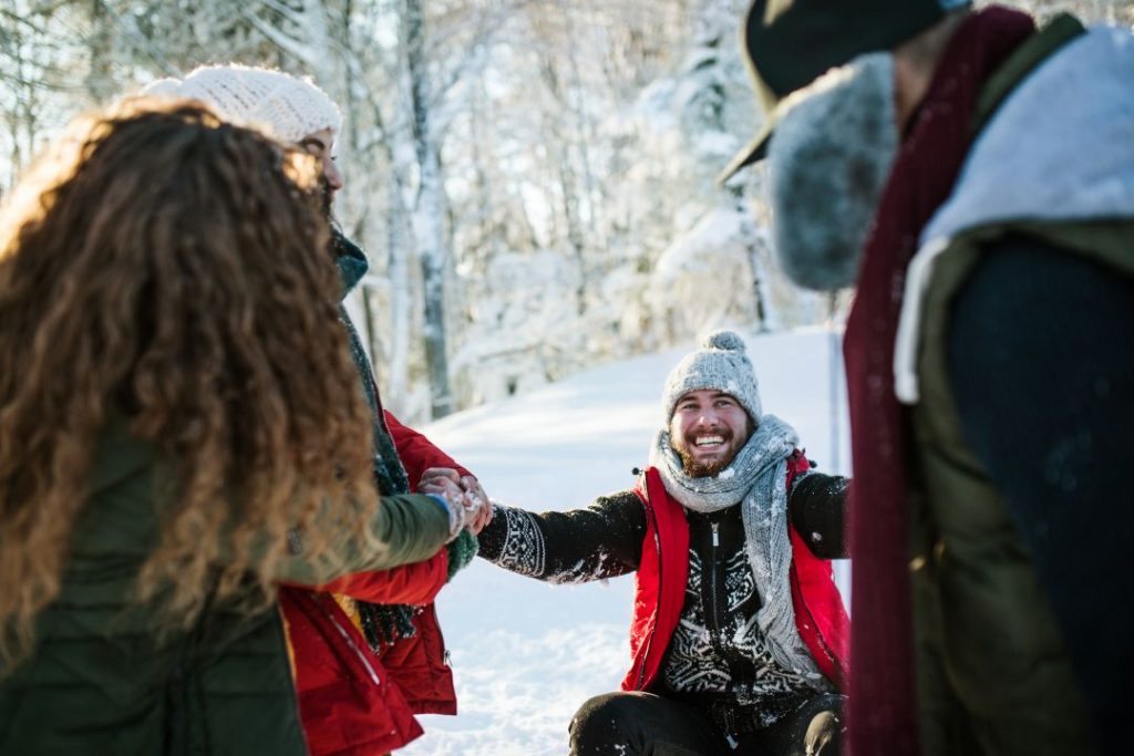 christmas gift activity voucher, a group of young friends having fun outdoors in winter forest