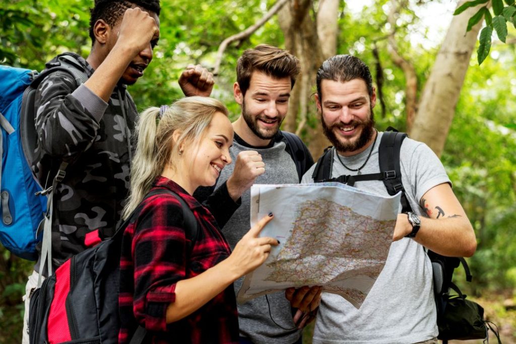 what makes a corporate day out successful large group, a group in a forest looking at a map for directions