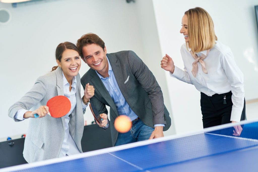 benefits of outdoor corporate days, a group of corporate employees high-fiving before an outdoor activity