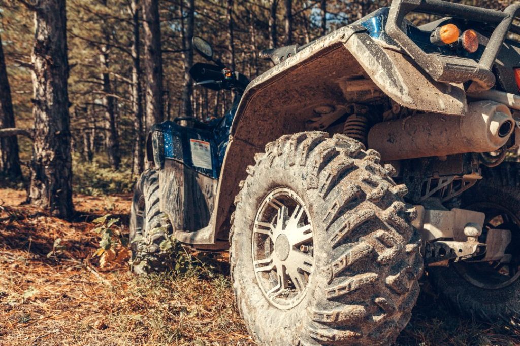 driving adventure vs zipline , close-up side view of an ATV quad bike