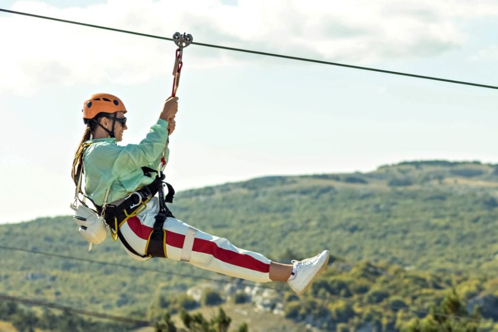 zipline vs driving experience UK, a person descending on a zipline
