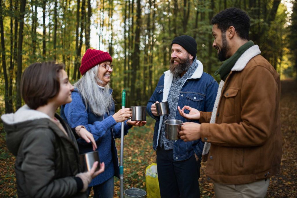 outdoor challenge team building day for employees UK, a group in a forest seen talking