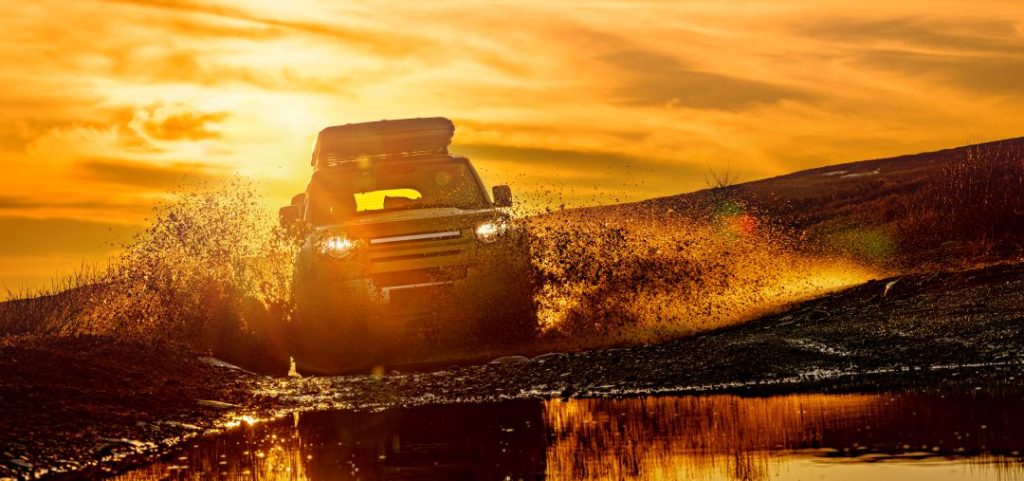off road driving team building, a land rover driving through tough terrain
