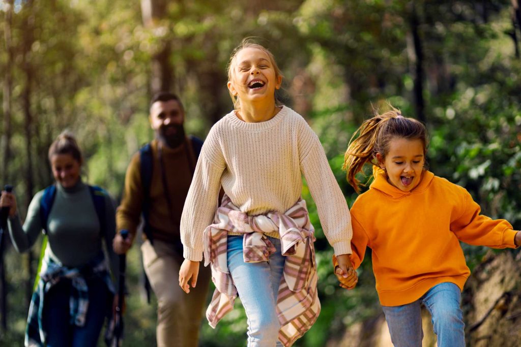 smiling family of four exploring nature.
