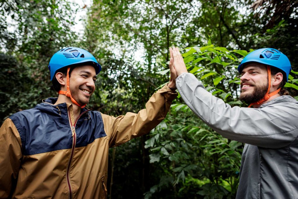 unique Father's Day experiences, Two men hi-fiving in the outdoors.