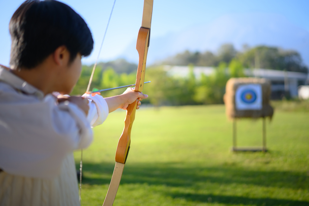 Outdoor Activity Ideas in the Midlands, person practising archery outdoors.