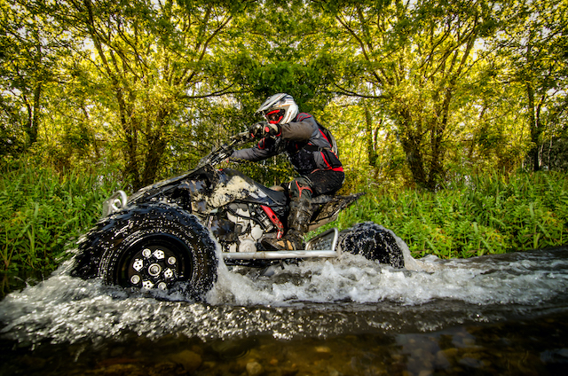 Things to do when it's raining, person quad biking in water.
