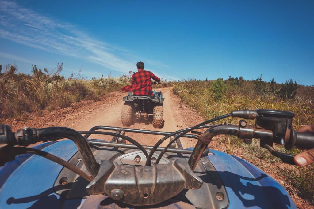 Wimbledon weekend plans, a man driving off road on an quad bike