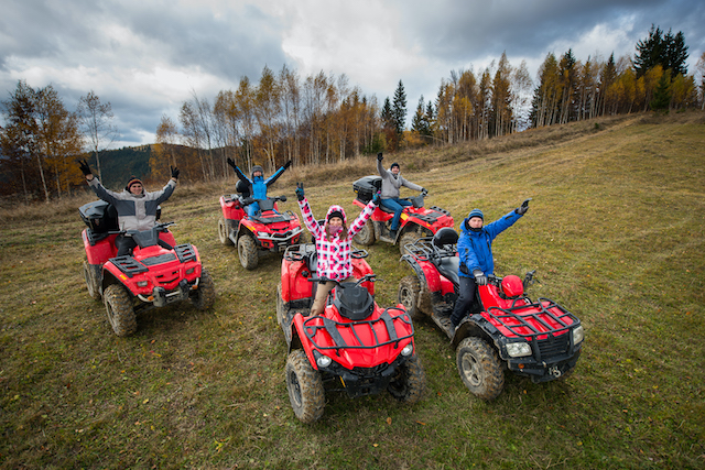 Building employee connections in hybrid teams, multiple people on quad bikes together.